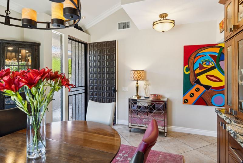 Dining table with pendant light and kitchen beyond