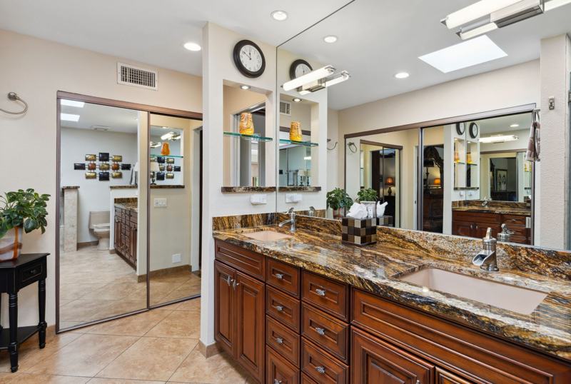 Primary bathroom with walk-in shower and dual sinks
